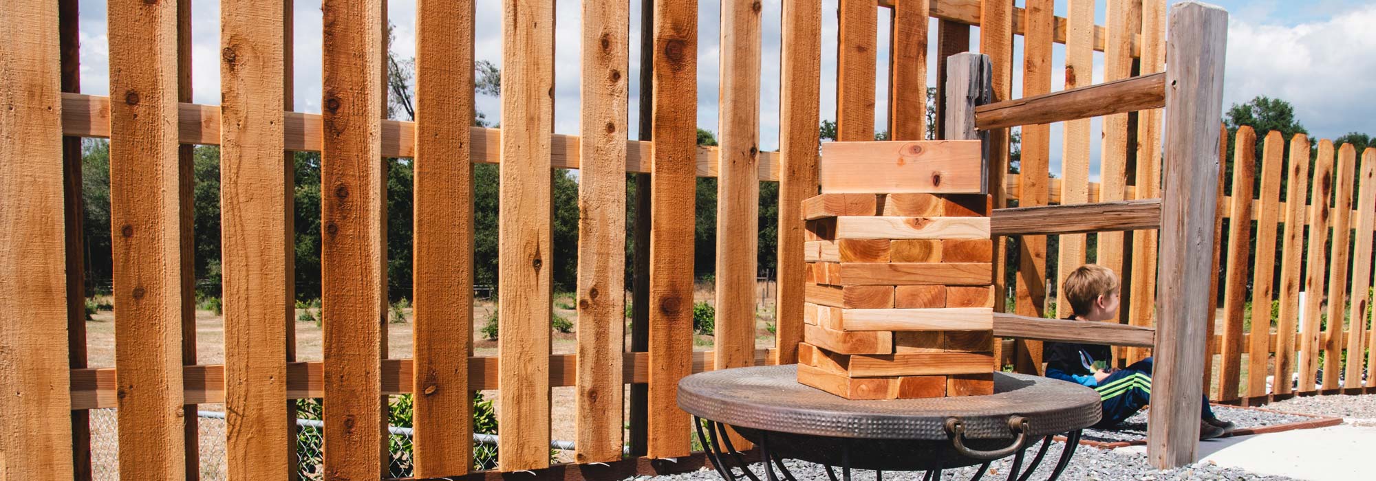 close up of a wood treated fence and jenga blocks
